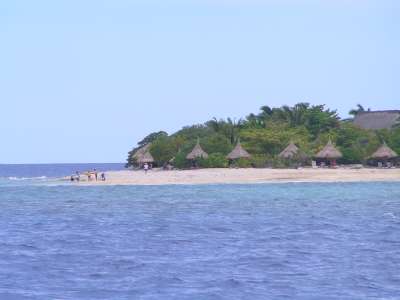 A Fiji beach with bures. 
